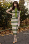 Satin Stripe Ellington Skirt: Effortless and classic, this high-end midi features wide cream and olive stripes, styled with a casual green sweater and tan heels.