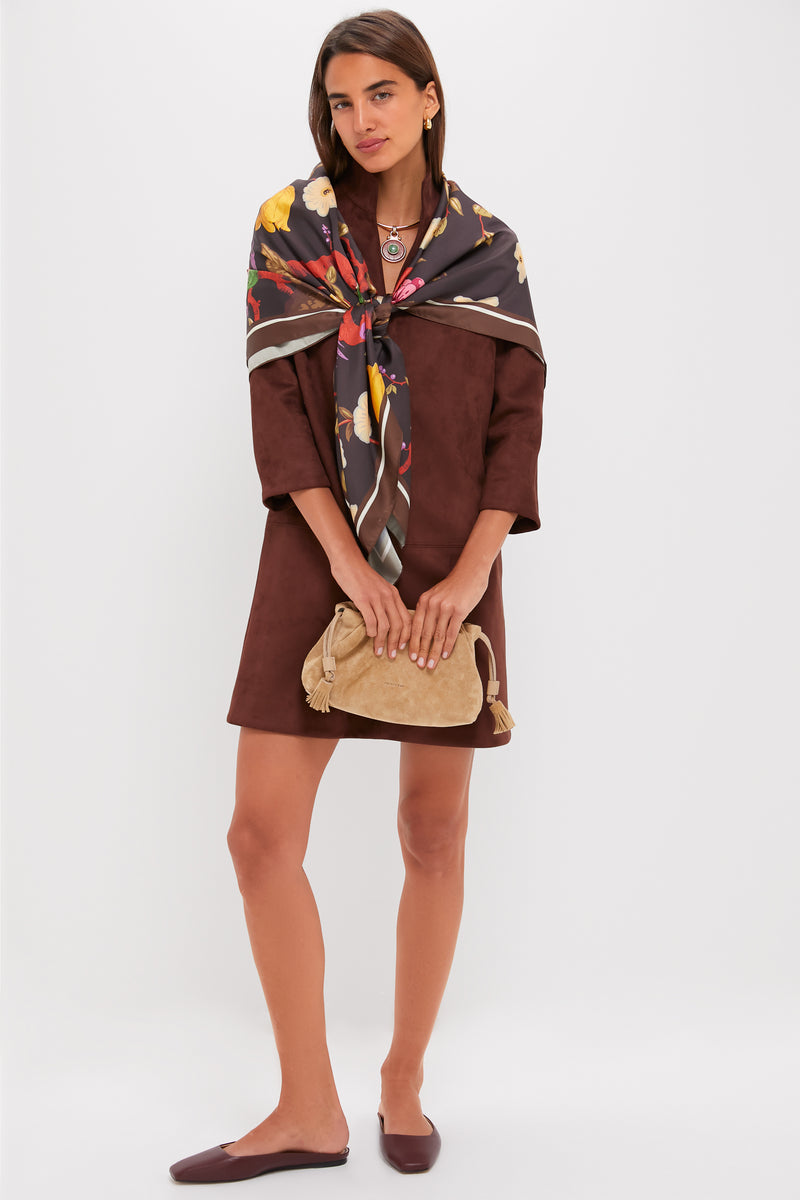 Woman models the classic Ganache Vegan Suede Clifton Dress, featuring three-quarter sleeves and V-neckline, paired with elegant accessories for an effortless, high-end look.