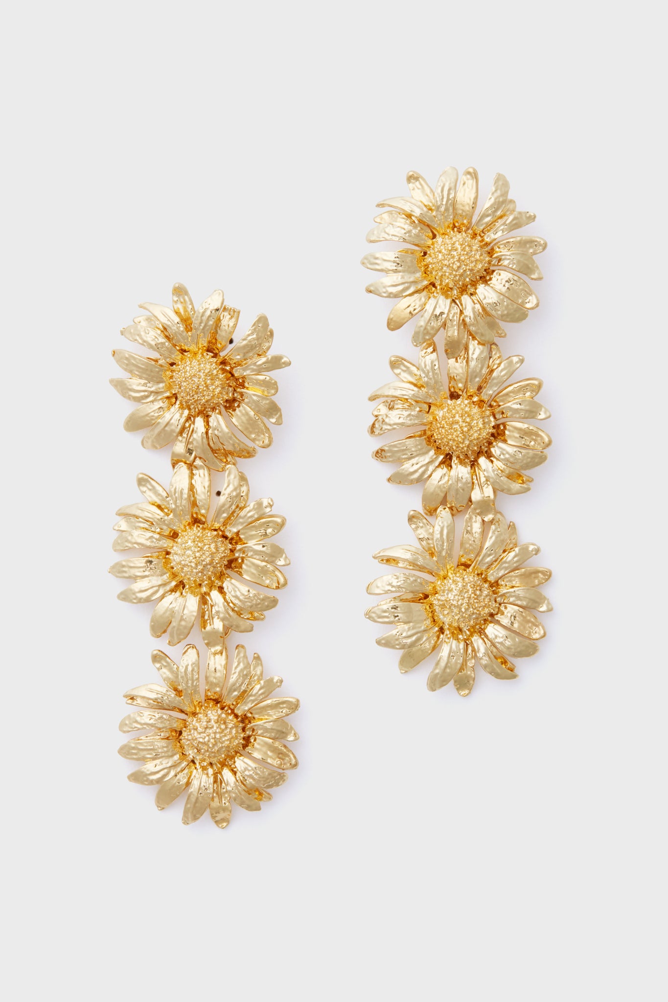 Gold Sunflower Drop Earrings by Petit Moments feature three daisy-shaped flowers stacked vertically—perfect feminine accessories from a female-owned brand.