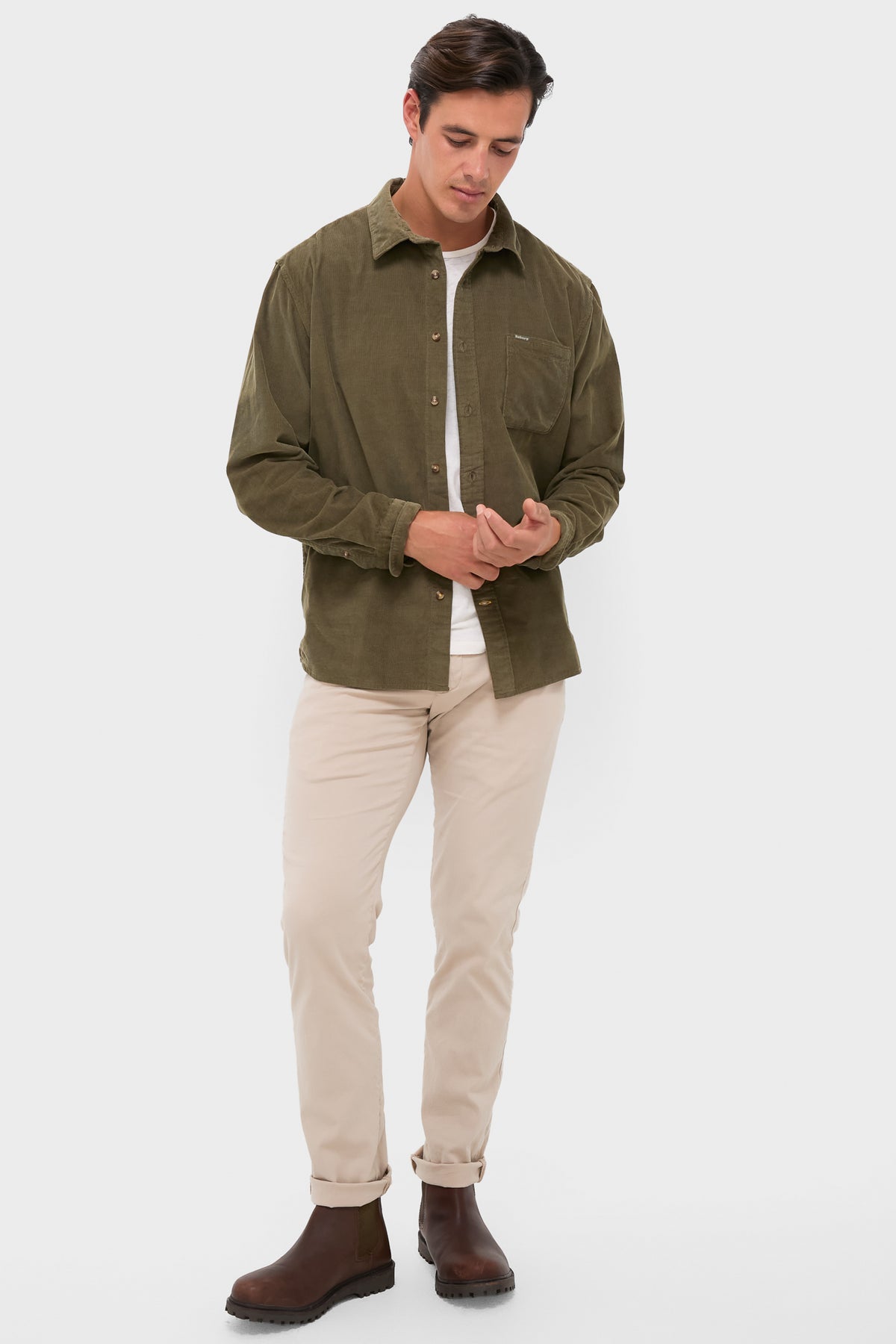 Model wearing the Olive Bramside Relaxed Cord Shirt, a classic, high-end piece with effortless style, featuring button cuffs and a chest pocket, paired with chinos and Chelsea boots.