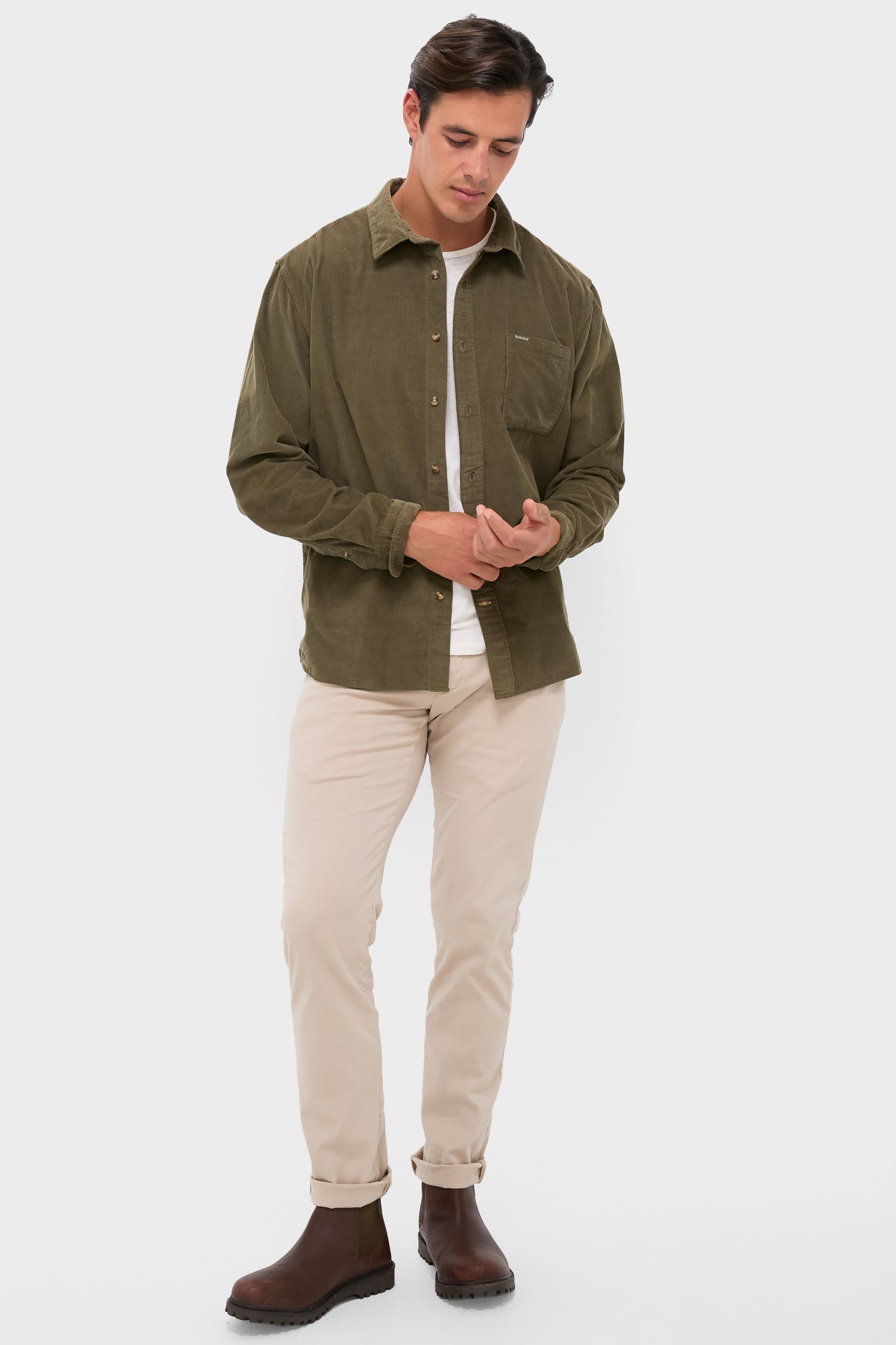 Model wearing the Olive Bramside Relaxed Cord Shirt, a classic, high-end piece with effortless style, featuring button cuffs and a chest pocket, paired with chinos and Chelsea boots.