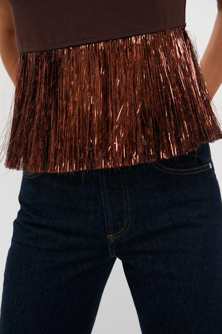 Bronze Metallic Fringe Francie Short Sleeve Blouse with dramatic copper fringe hem, exuding classic, effortless style. Perfect for a fun, high-end look with dark denim jeans.