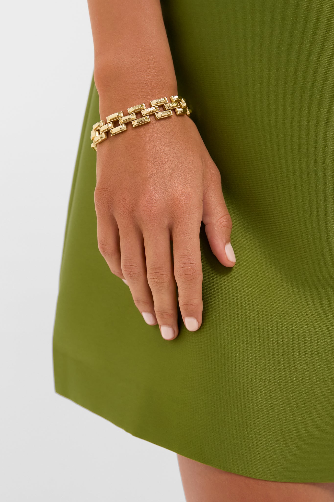 The image features the Pathway Petite Link Bracelet in Gold, a classic and effortless accessory with chunky interlocked rectangular links, exuding a high-end, versatile charm on a woman's wrist.
