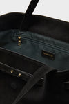 Black Suede Blaine Tote interior with dark lining, gold zip pocket, and TUCKERNUCK label; classic, high-end design for effortless, fun style.