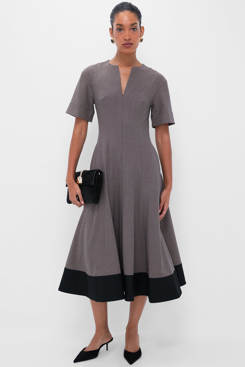 Model wearing classic, fitted midi dress with houndstooth pattern; accessorized with Onyx Alva Earrings, exuding an effortless, high-end style. Perfect for fun, confident looks.
