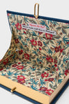 Inside the Indigo Latim Manhattan Cocktail Book Clutch, showcasing a classic, high-end floral lining with a handmade label, reflecting effortless style and fun sophistication.