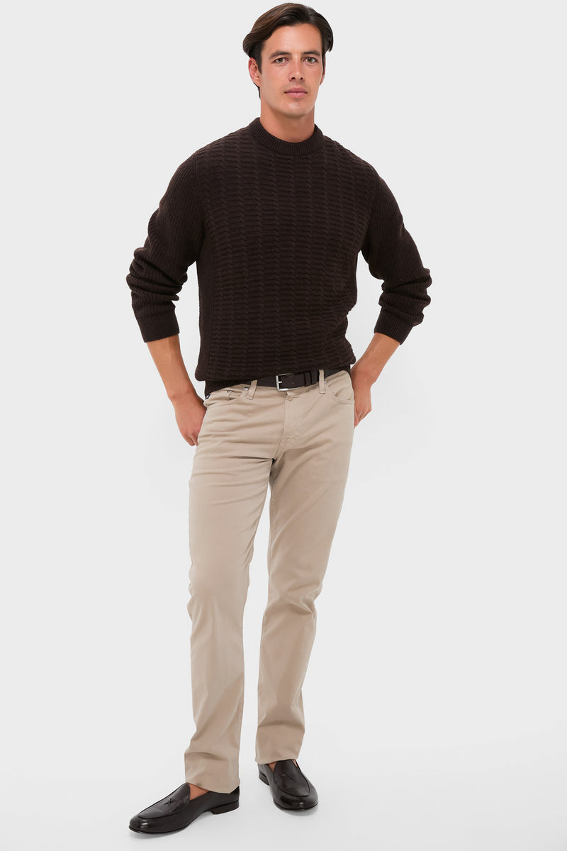 Young man wearing the classic Dark Oak Cleveland Crew Neck Sweater, paired with light beige chinos and black loafers, showcasing an effortless and high-end style.