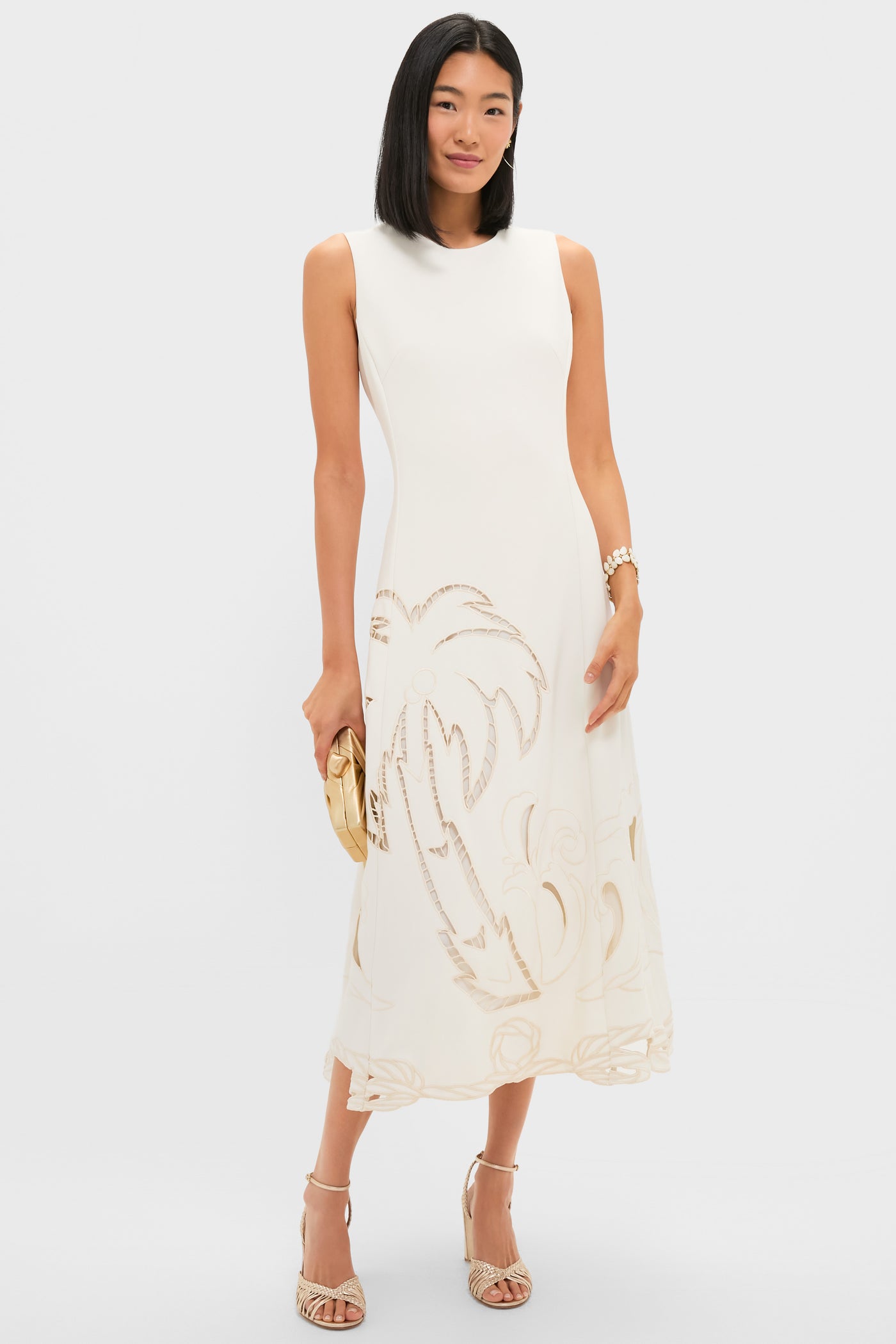 Woman in a classic white dress showcases the Mermaid Garden Vine Bracelet, 7 - MOP, an effortless, high-end piece with mother of pearl and gold detailing.
