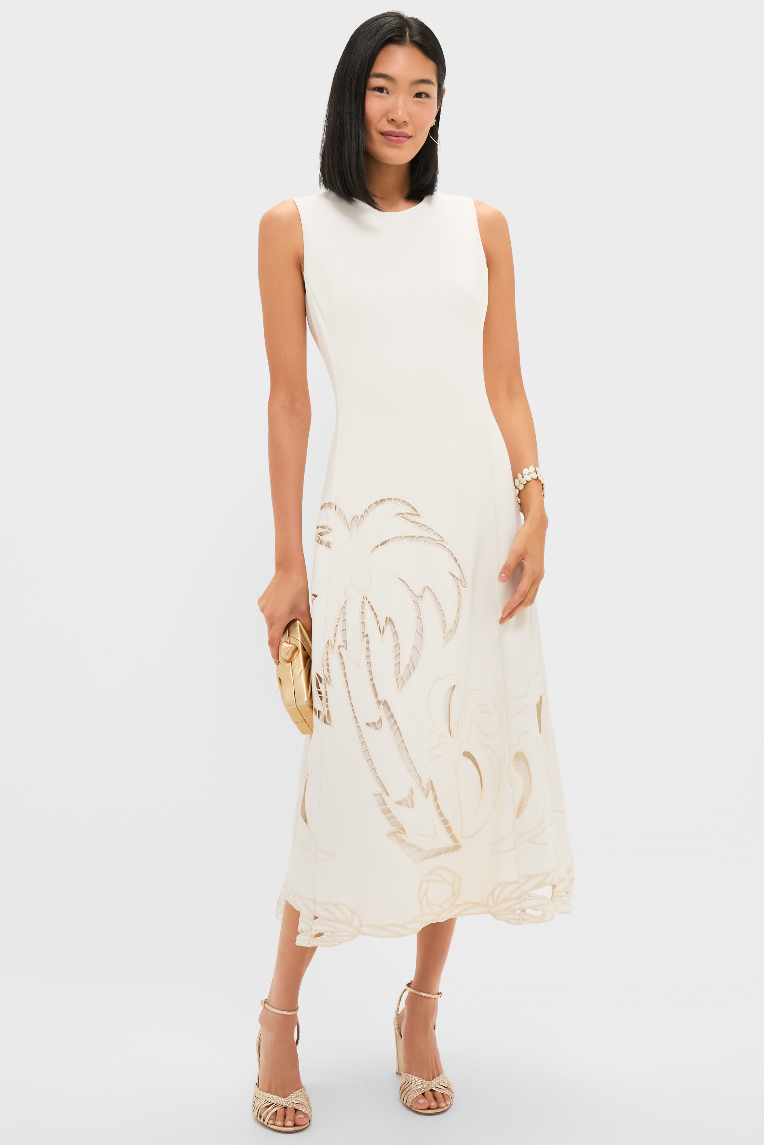 Woman in a classic white dress showcases the Mermaid Garden Vine Bracelet, 7 - MOP, an effortless, high-end piece with mother of pearl and gold detailing.
