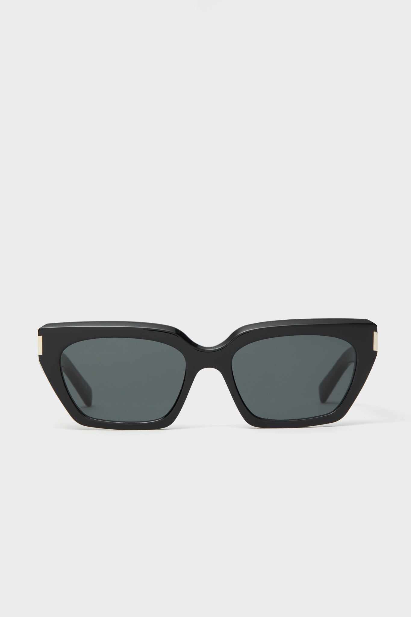 Saint Laurent black cat-eye sunglasses featuring dark lenses and gold corner accents, inspired by Yves Saint Laurent.