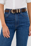 Chocolate Suede Western Belt with gold-tone buckle, effortlessly cinching high-rise jeans for a classic, high-end look. Paired with a white top, conveying fun sophistication.