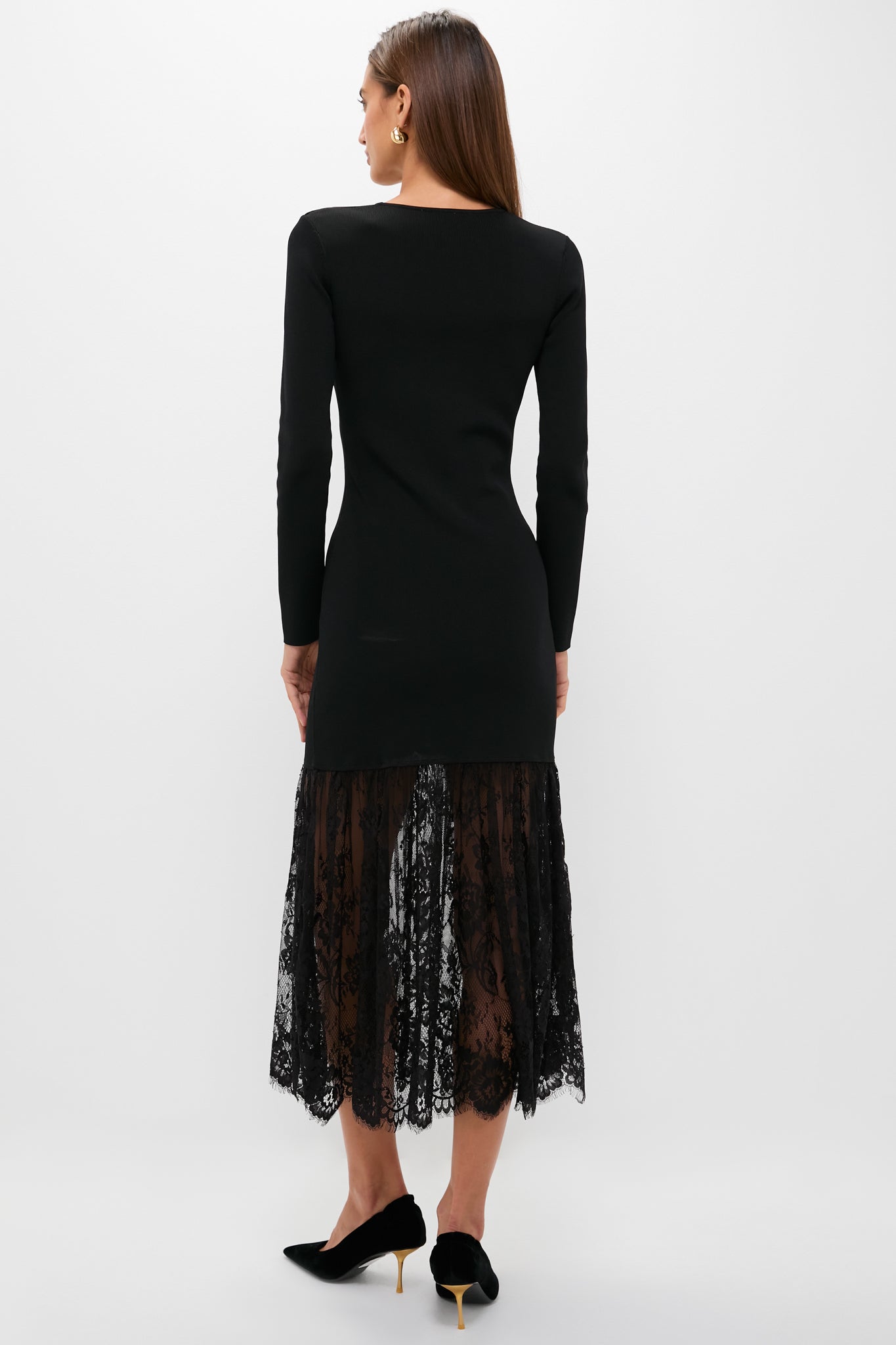 Woman wearing the Black Knit Giavanna Maxi Dress, featuring a classic fitted bodice and an effortless, fun lace skirt, styled with high-end slingback pumps.