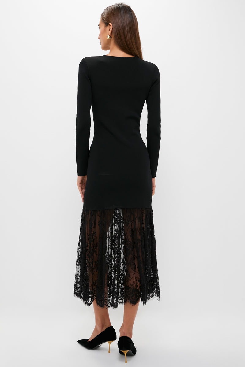 Woman wearing the Black Knit Giavanna Maxi Dress, featuring a classic fitted bodice and an effortless, fun lace skirt, styled with high-end slingback pumps.