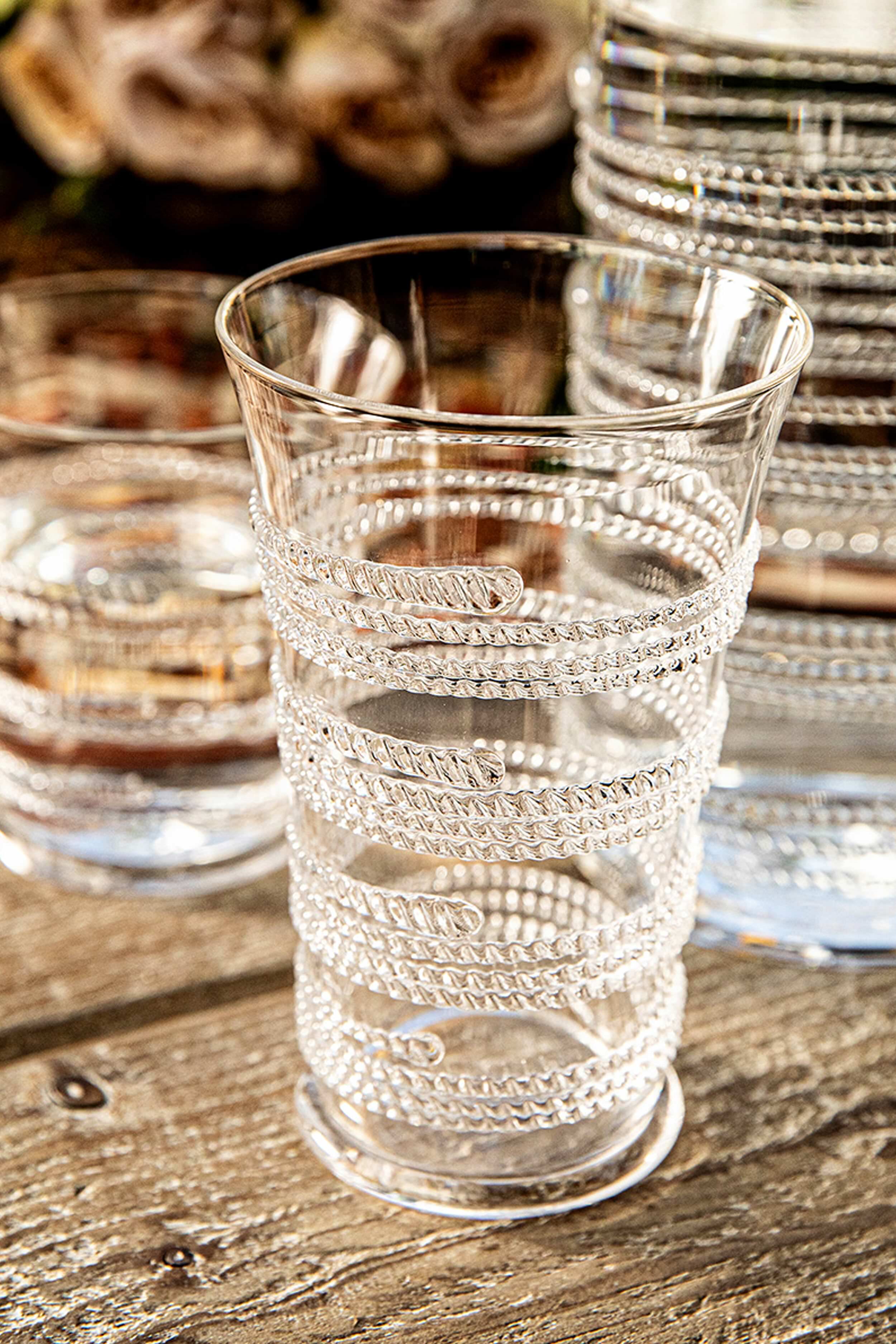 Ella Large Tumbler features a classic, effortless spiral pattern, mouth-blown by artisans. This high-end glassware adds fun sparkle to any drink, embodying Tuckernuck’s cool, confident style.
