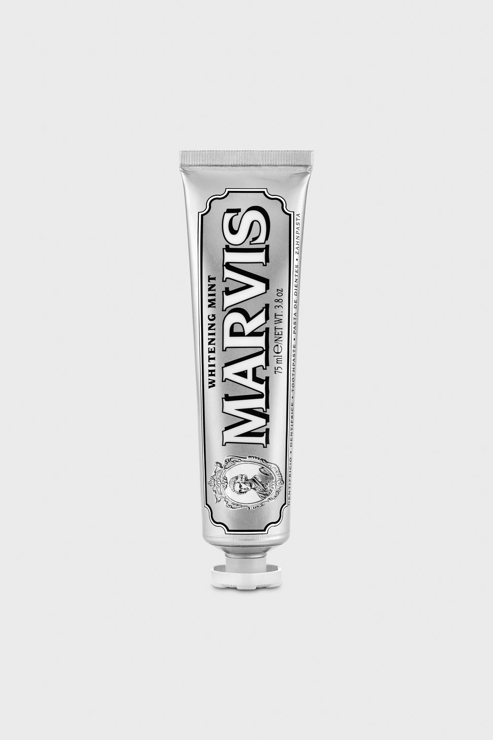 A Marvis toothpaste tube stands upright, offering fresh breath and a whiter smile.