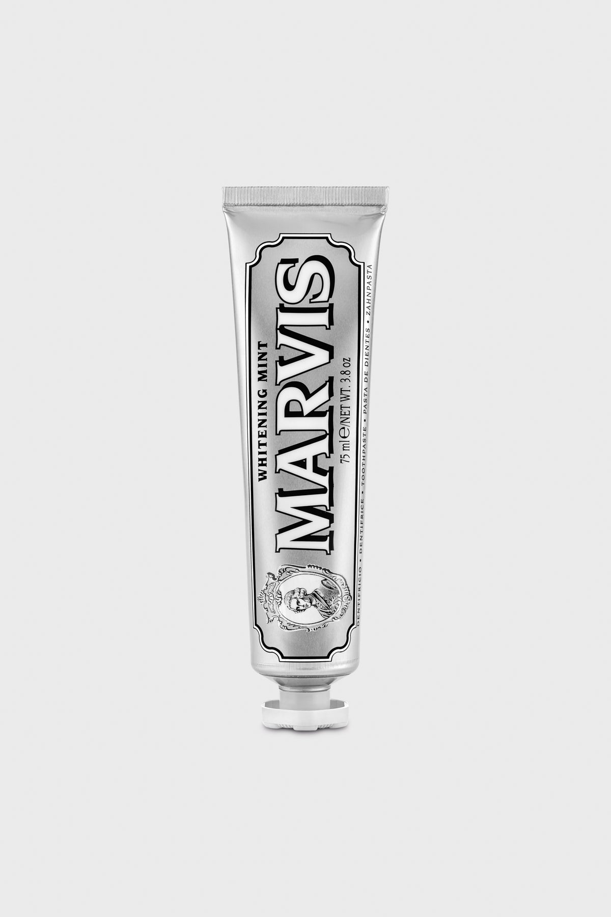 A Marvis toothpaste tube stands upright, offering fresh breath and a whiter smile.