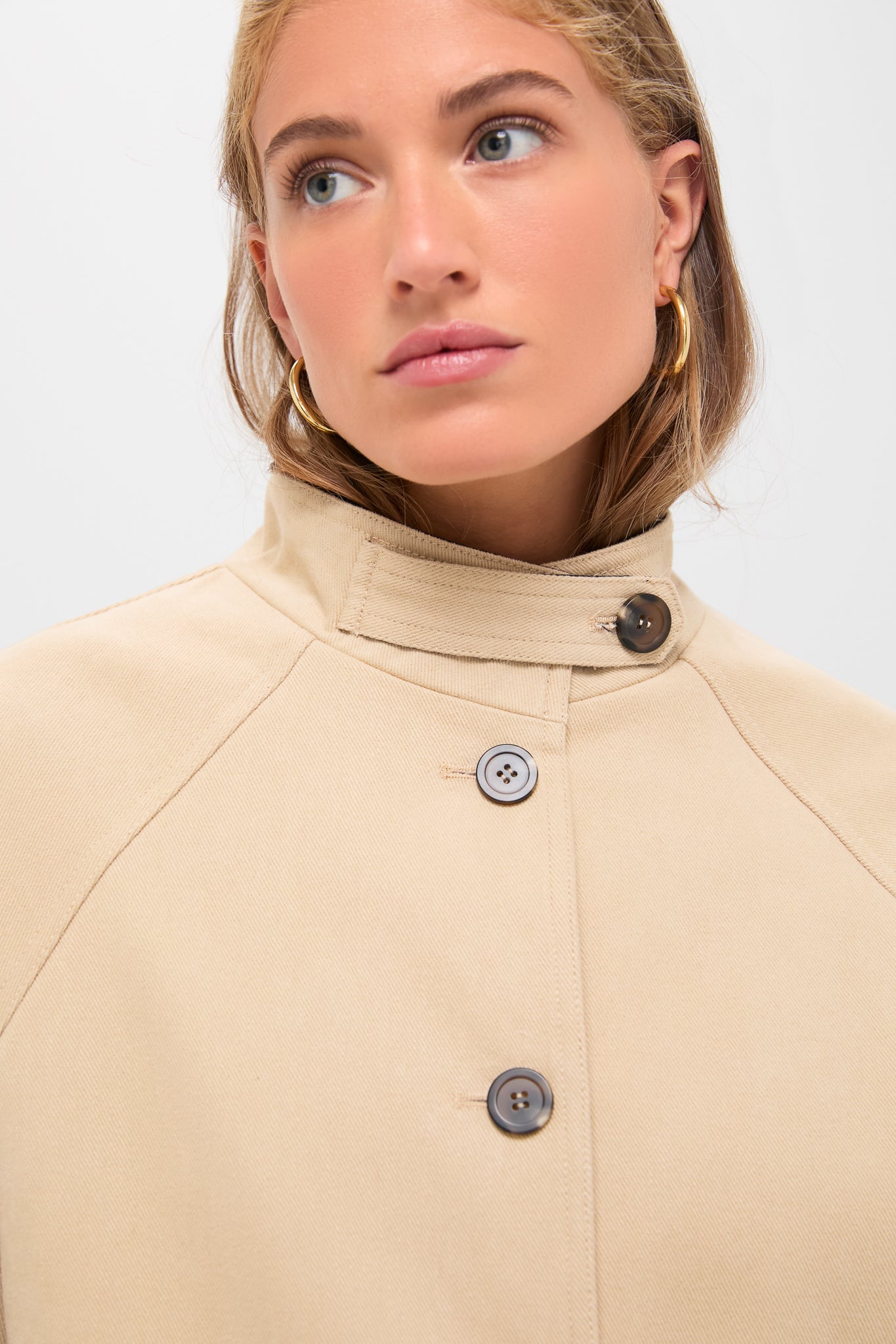 Classic Beige and Navy Oakley Coat with buttoned stand-up collar and raglan seams, showcasing effortless style and high-end design for a fun, modern wardrobe.