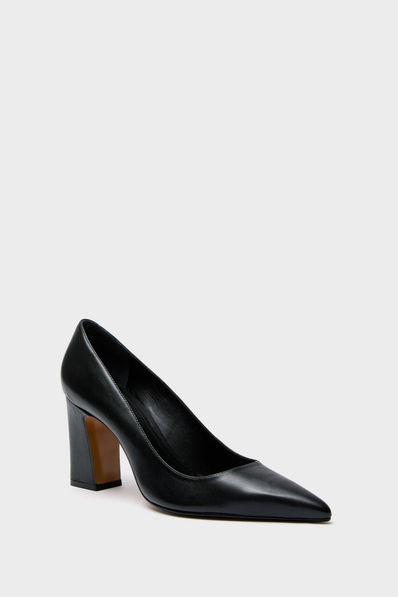 Schutz black leather pumps with a pointed toe and thick block heel, stylishly showcased.
