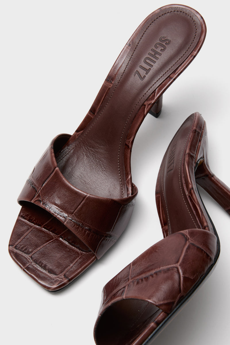 Root Brown Posseni Heels: Classic, effortless heeled mules in dark brown, crocodile-embossed leather with a square toe and angled heel, exuding fun and high-end style.