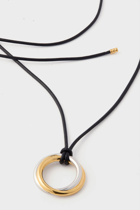 Mixed Lucy Williams Entwine Pendant Cord Necklace: a classic, high-end design featuring interlocked gold and silver rings on a black cord, offering an effortless and fun style statement.