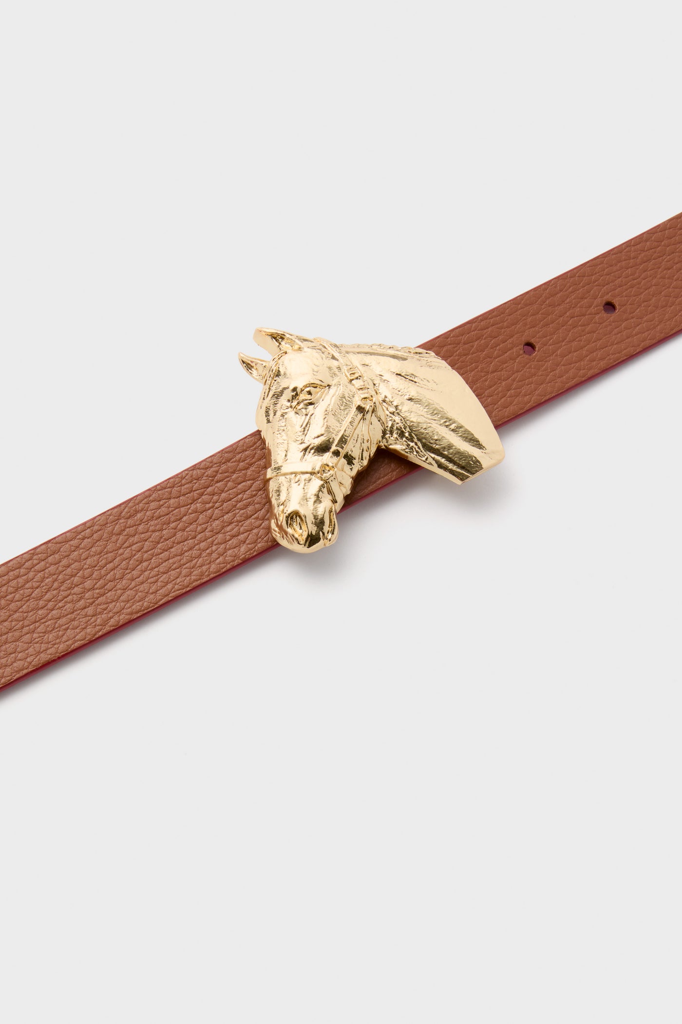 Gold Petite Ivy Buckle: classic sculpted horse head in polished brass, effortlessly elevating outfits with its high-end charm. Fun, versatile accessory for a tailored, stylish look.
