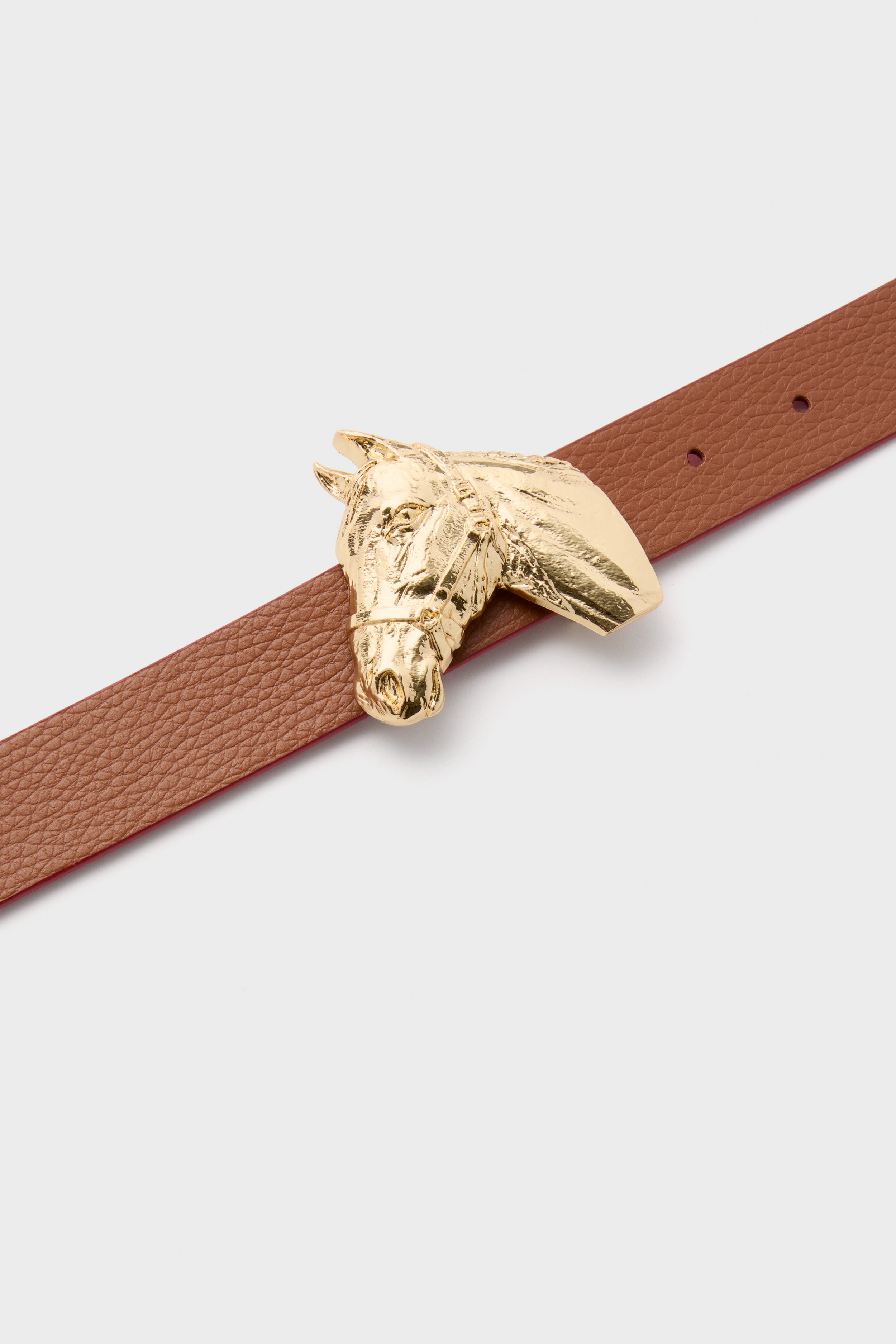 Gold Petite Ivy Buckle: classic sculpted horse head in polished brass, effortlessly elevating outfits with its high-end charm. Fun, versatile accessory for a tailored, stylish look.