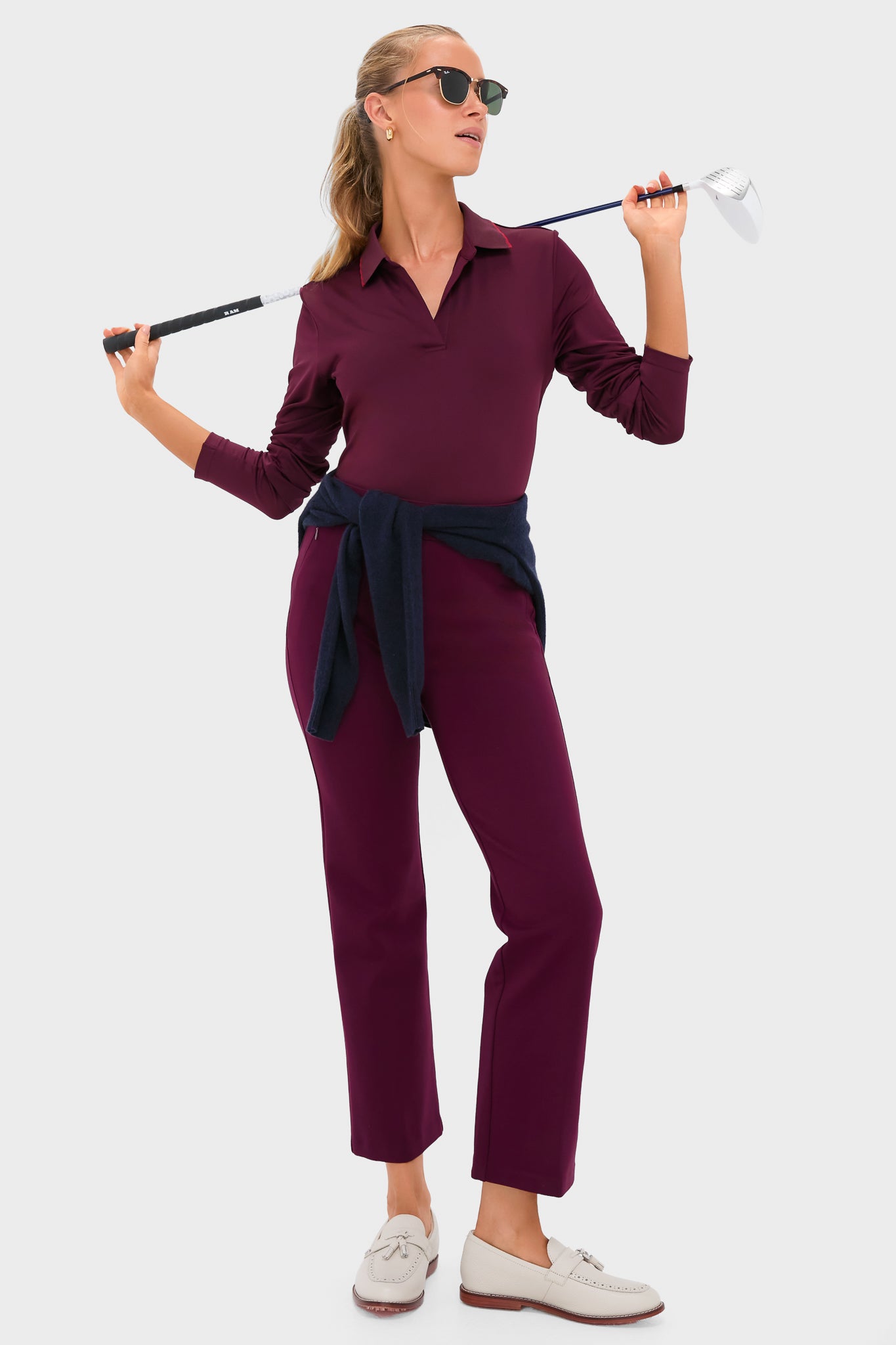 Woman showcasing classic Winetasting 28 Inch Compression September Pant, embodying an effortless, high-end style. Pants feature side zip pockets and slightly flared silhouette, perfect for versatile, fun dressing.