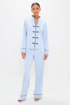 Woman in a classic, light blue Pima Cotton Wilford Women's Pajama Set with Mandarin collar and black piping, embodying effortless style and high-end comfort.