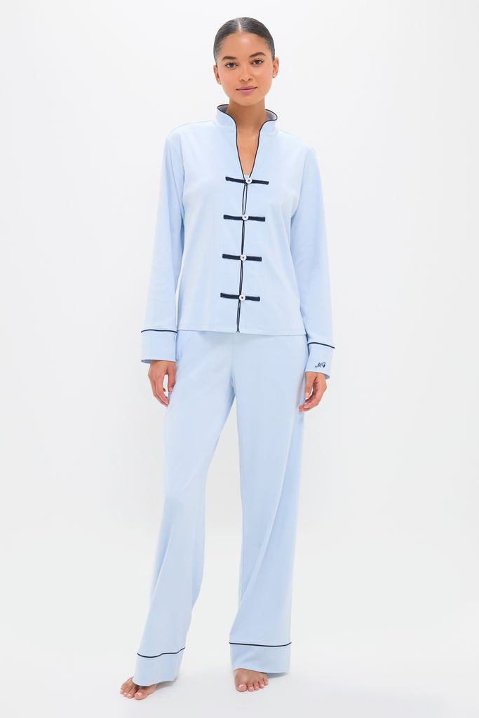 Woman in a classic, light blue Pima Cotton Wilford Women's Pajama Set with Mandarin collar and black piping, embodying effortless style and high-end comfort.