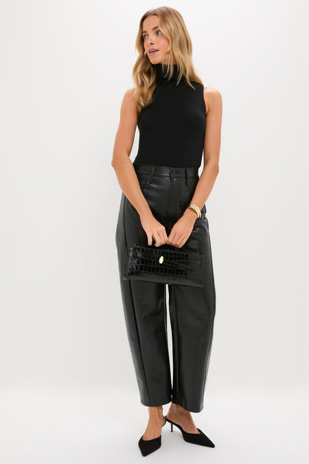 Woman in sleek black attire, showcasing a classic, effortless look with the High Polish Gold Lennon Bangle, featuring deep contours and a high-end finish.