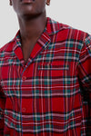 A person models a Petite Plume red plaid button-up shirt with a chest pocket, shown from shoulders to mid-torso against a plain background—blending classic style and modern luxury cotton sleepwear.