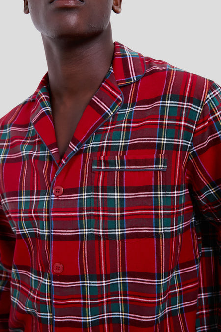 A person models a Petite Plume red plaid button-up shirt with a chest pocket, shown from shoulders to mid-torso against a plain background—blending classic style and modern luxury cotton sleepwear.