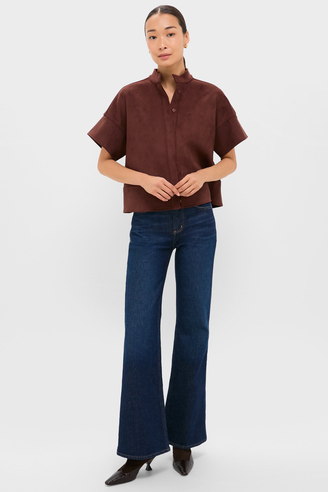 Model wearing the classic Ganache Vegan Suede Trapunto Stitch Sofia Shirt, showcasing an effortless, boxy silhouette with trapunto stitch details, paired with high-end flared jeans.