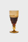 Amber Ella Goblet, a classic, high-end amber-tinted glass with effortless spiraling detail, mouth-blown for a fun, elegant touch to any occasion.