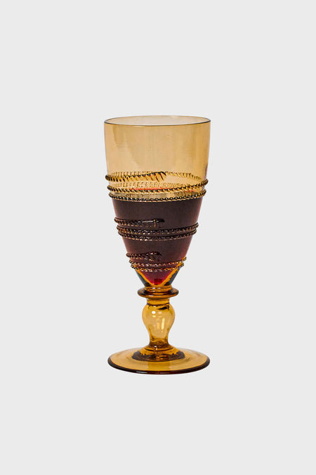 Amber Ella Goblet, a classic, high-end amber-tinted glass with effortless spiraling detail, mouth-blown for a fun, elegant touch to any occasion.