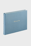 Slate Blue Pebble Grain Guest Book with Guests in gold embossing; a classic, high-end leather-bound register for effortless and fun event memories.