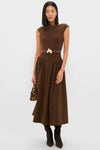 Model in a sleeveless chocolate-brown midi dress featuring the Gold Petite Ivy Buckle, exuding a classic and effortless high-end style with a fun, polished finish.