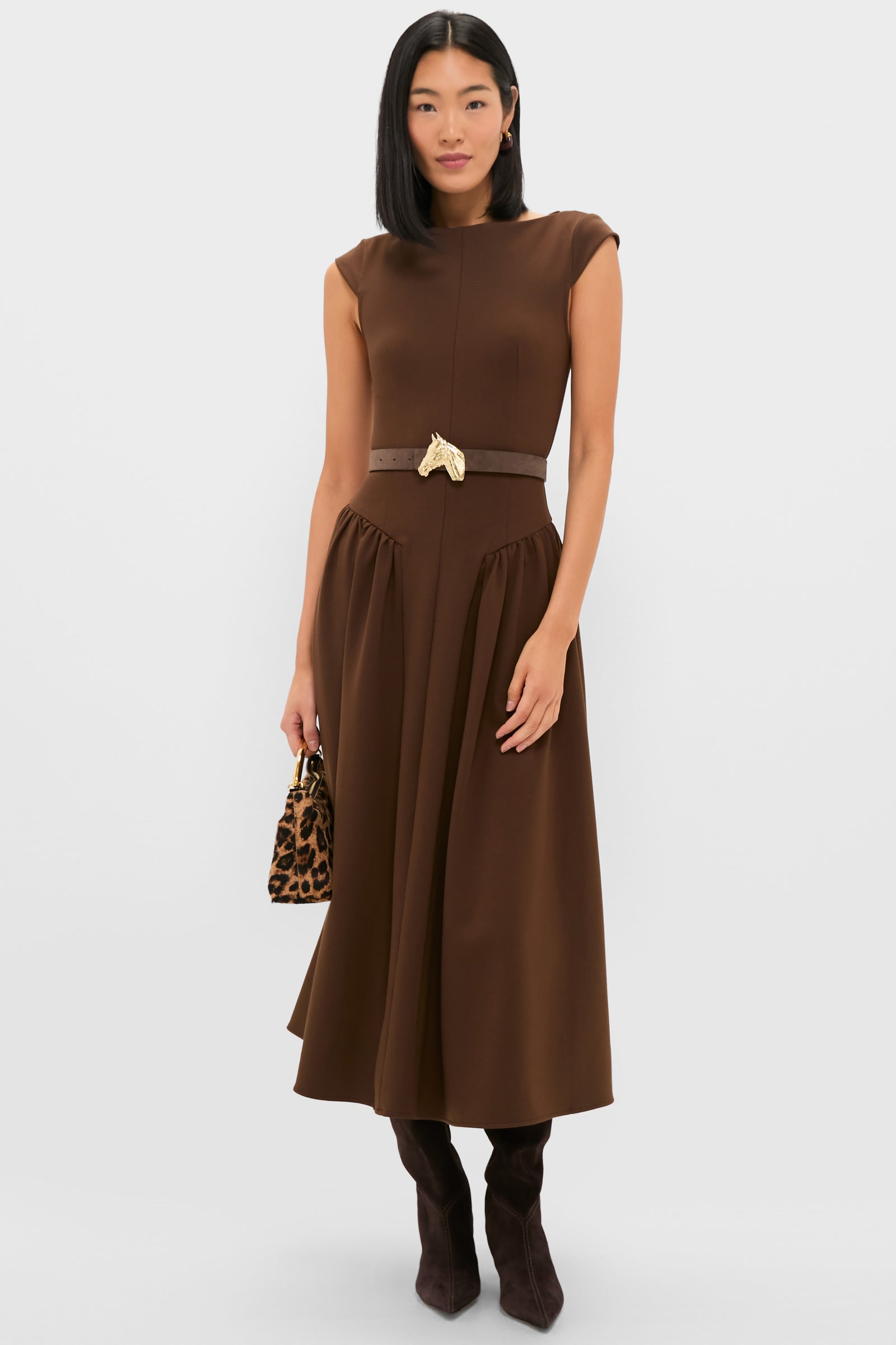 Model in a sleeveless chocolate-brown midi dress featuring the Gold Petite Ivy Buckle, exuding a classic and effortless high-end style with a fun, polished finish.