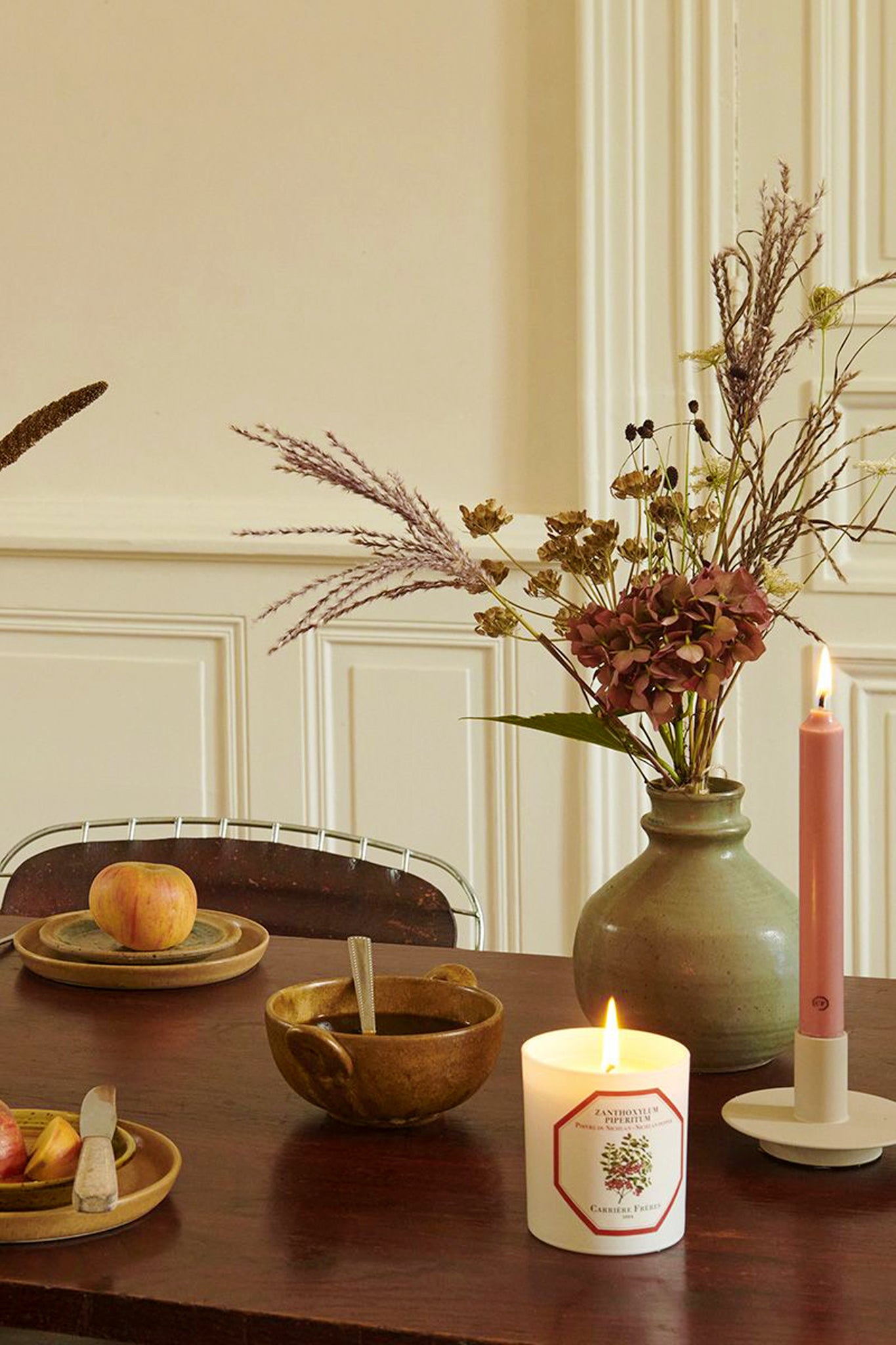 Spearmint Candle lit on a classic tabletop, surrounded by a slim taper candle, rustic bowl, and dried floral arrangement; embodies effortless, high-end style and fun ambiance.