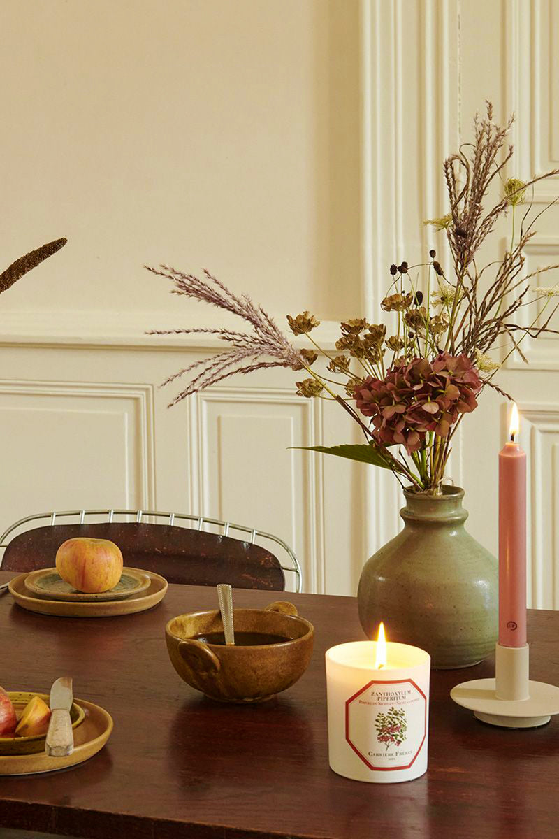 Spearmint Candle lit on a classic tabletop, surrounded by a slim taper candle, rustic bowl, and dried floral arrangement; embodies effortless, high-end style and fun ambiance.