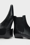 Black Wally Chelsea Boot: classic ankle-high leather boots with elastic panels and low block heels, offering an effortless, high-end style for a fun, versatile wardrobe.