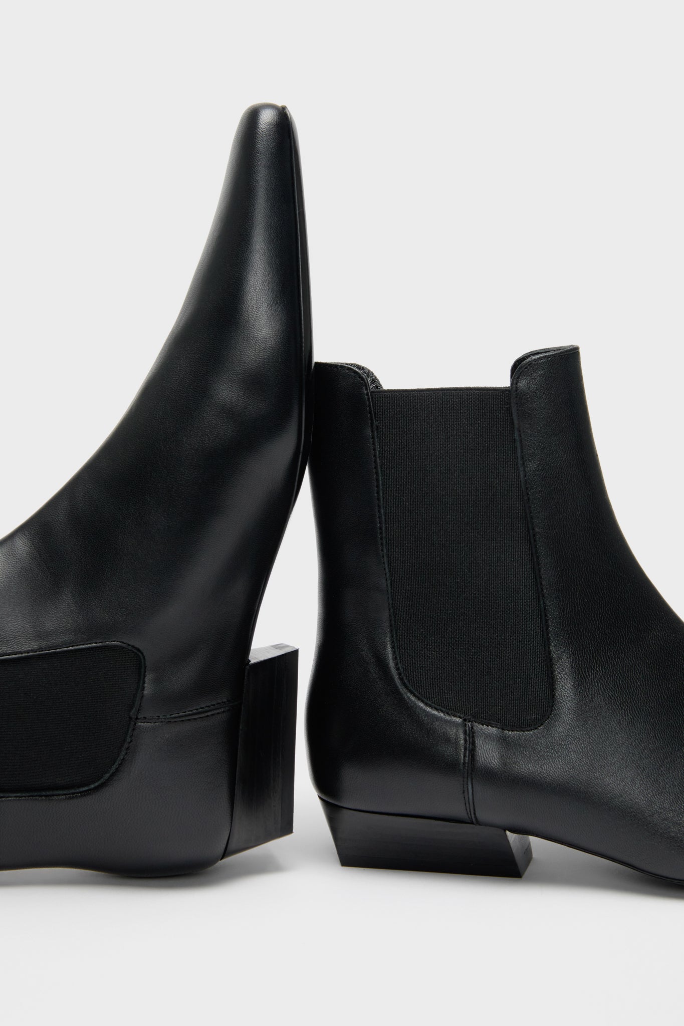 Black Wally Chelsea Boot: classic ankle-high leather boots with elastic panels and low block heels, offering an effortless, high-end style for a fun, versatile wardrobe.