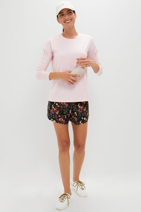 Person wearing the classic Pink Long Sleeve Performance Jersey Ryan Boyfriend Tee, styled effortlessly for fun, exuding high-end comfort and versatility, holding a water bottle.