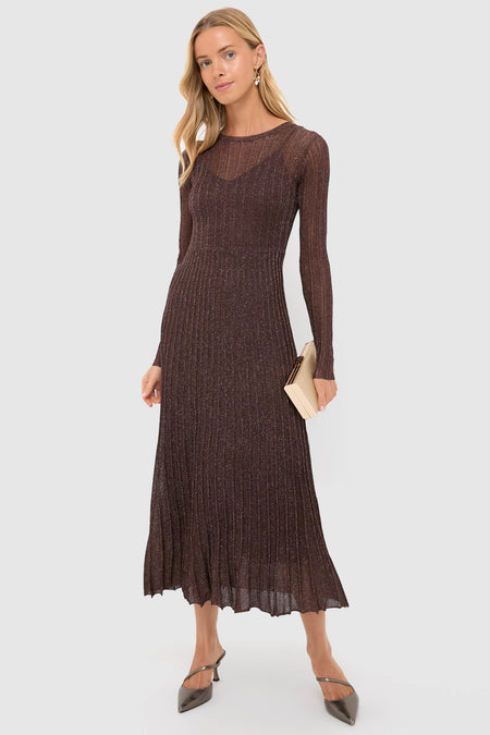 Woman wearing a classic, shimmering brown dress, highlighting the Pearl and Gold Charm Giselle Earrings, which add an effortless, high-end touch with their playful design.