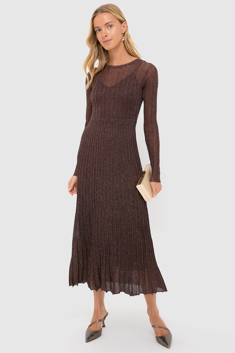 Woman wearing a classic, shimmering brown dress, highlighting the Pearl and Gold Charm Giselle Earrings, which add an effortless, high-end touch with their playful design.