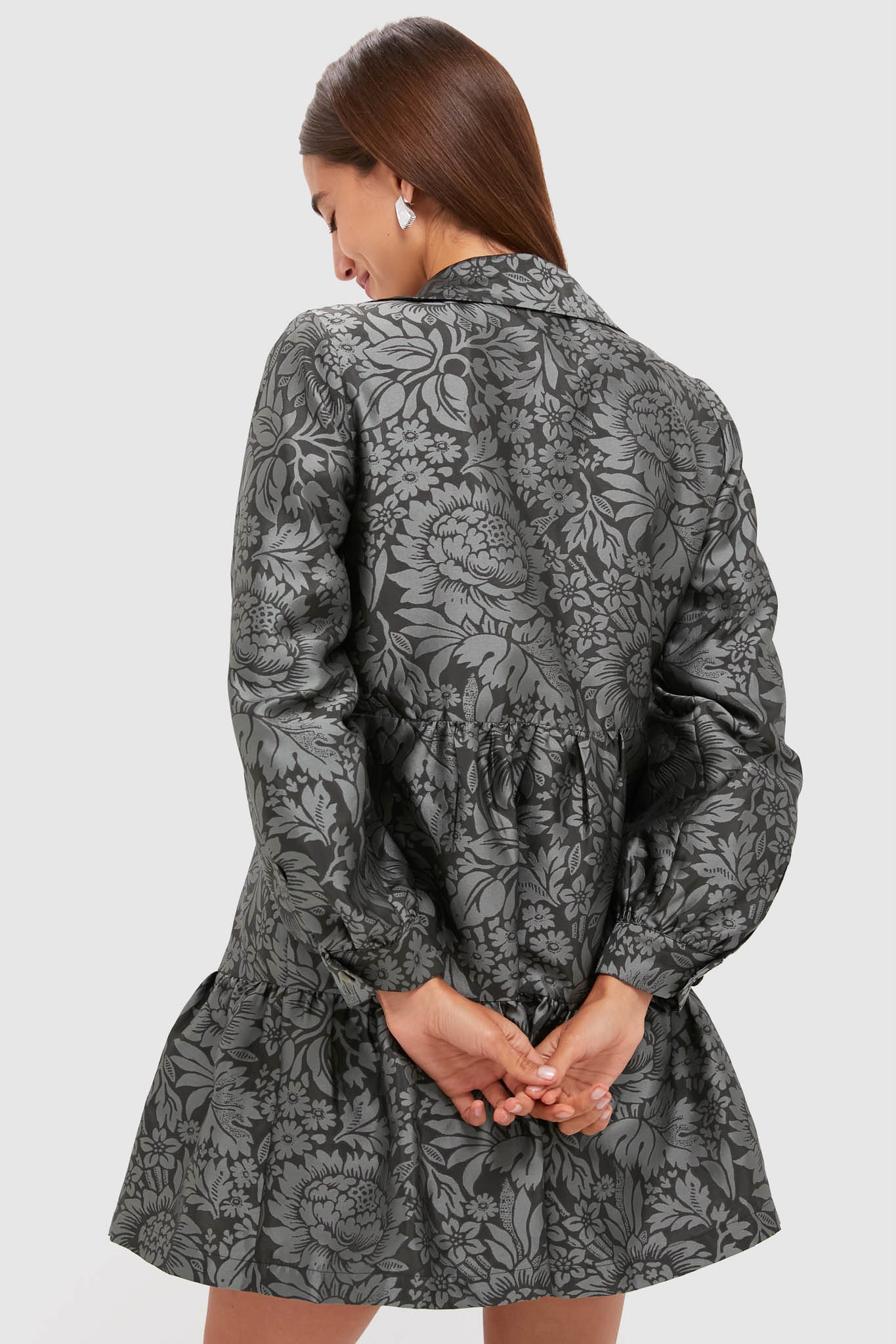 Woman in the Emerald Mirasol Jacquard Alette Dress, showcasing a classic, effortless design with a gathered waist and subtle ruffle hem, perfect for high-end occasions.