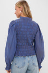 Morgan Blue Willow Top: back view of a classic, effortless, smocked blouse with ruffled cuffs and hem, styled with light-wash, high-waisted denim for a fun, high-end look.