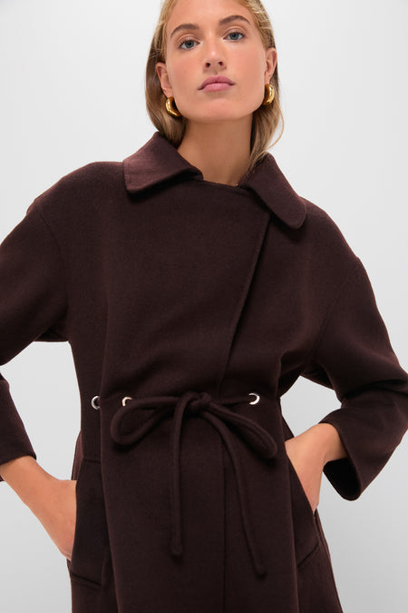 Young woman models the Chocolate Kate Coat, a classic, high-end wool blend with a V-collar, drawstring waist, and piped pockets, embodying effortless and fun style.