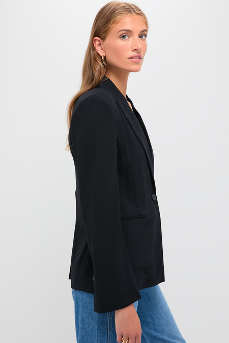 Young woman models the Midnight Boy Blazer, a classic, oversized one-button blazer with a peak lapel, exuding effortless, high-end style through its drapey wool crepe fabric.