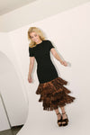 Woman in Black & Bronze Metallic Fringe Francie Short Sleeve Maxi Dress, exuding classic, effortless style with a body-skimming fit and fun, high-end fringe detailing.